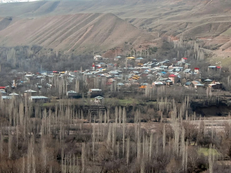 a hillside area with a village in the distance