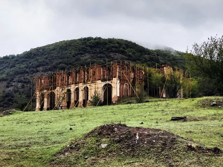 the building is rusty on the side of a hill