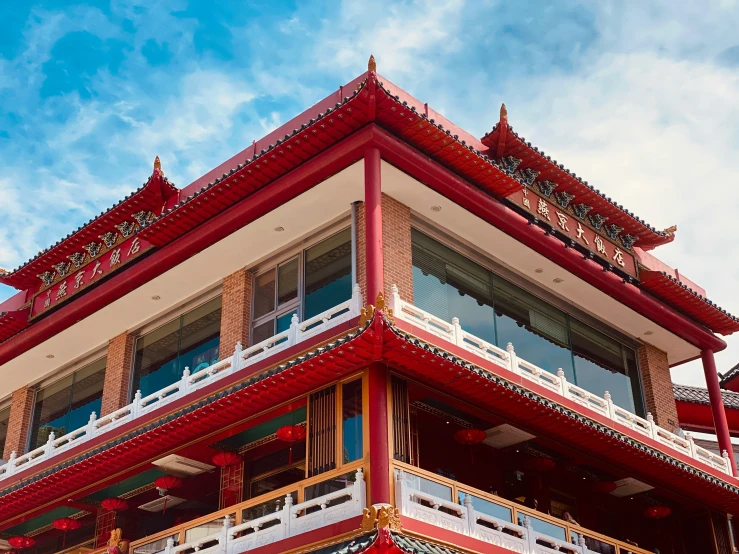 a red, yellow, and white building with balconyes and balconies