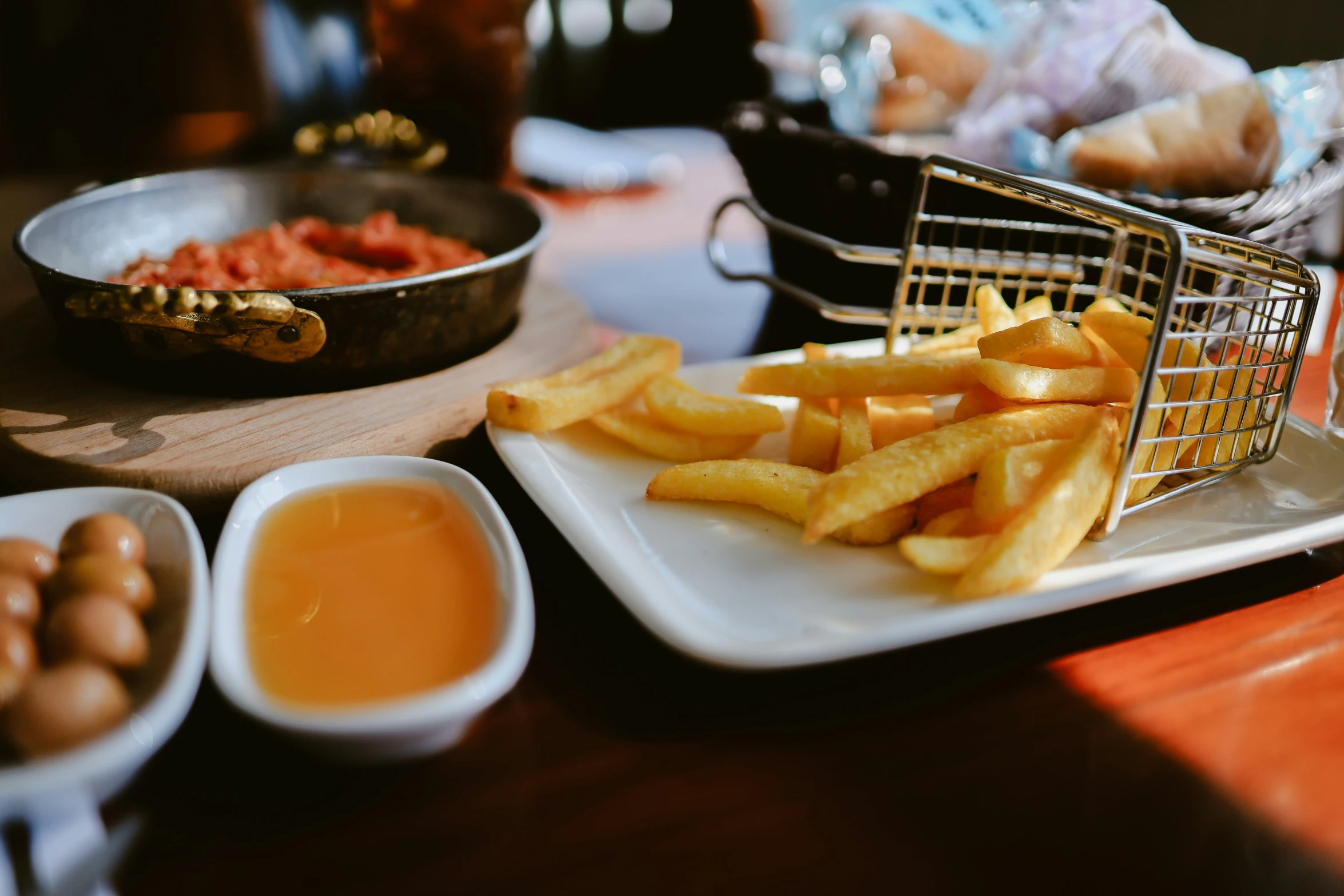 there is french fries and sauce on the table