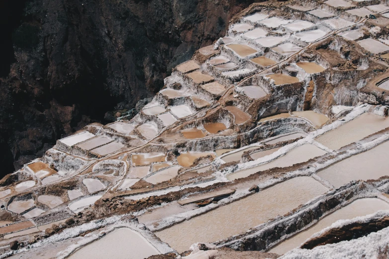 there are tiles on the ground and one is covered in snow