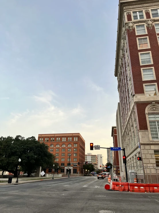 traffic cones at an intersection with a very tall building