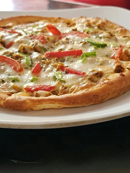 a pizza sitting on top of a white plate on a table