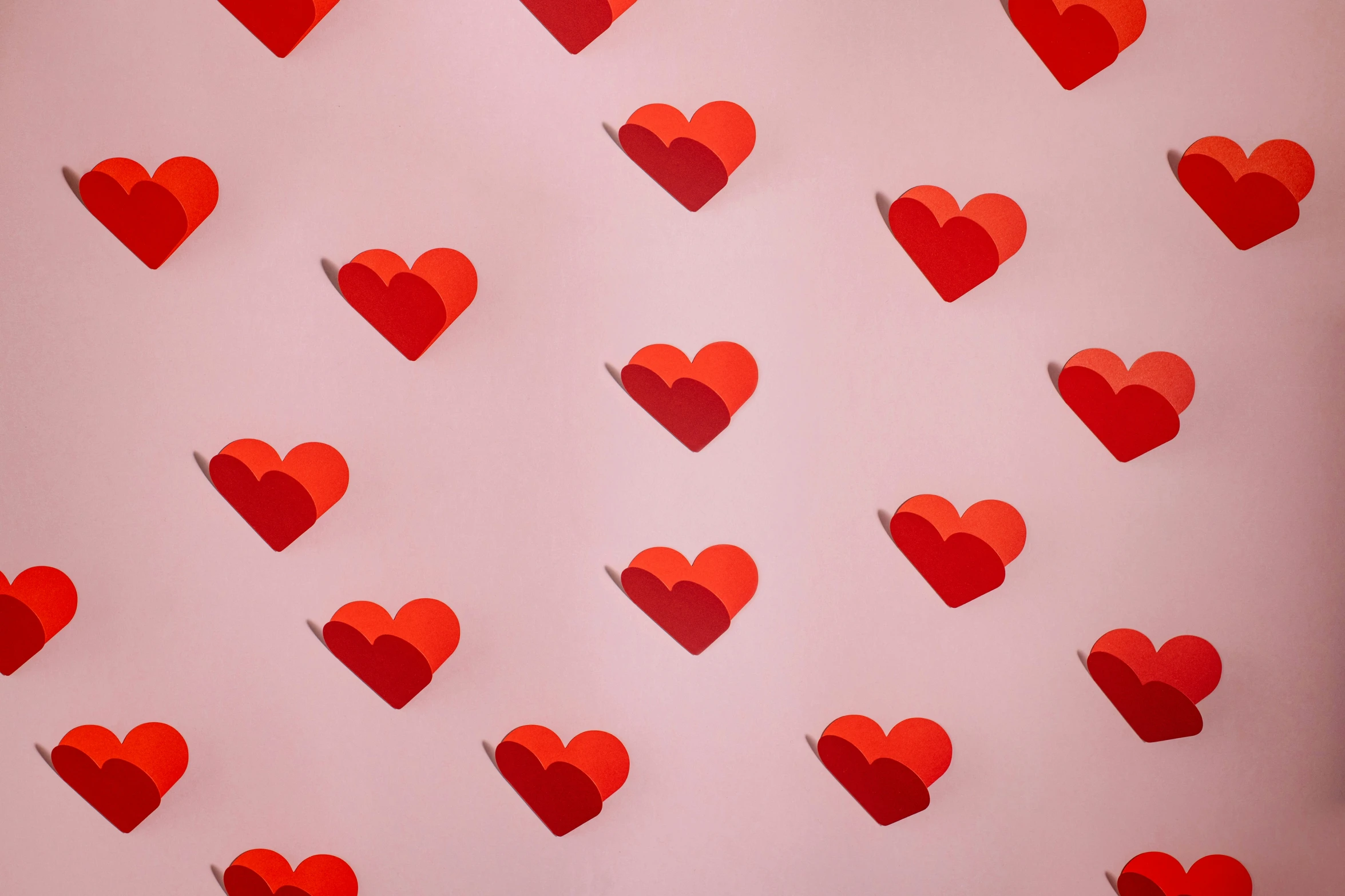 heart shaped cut out of some red paper on the wall