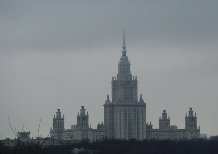 a tower structure in the background of trees on the other side of the building