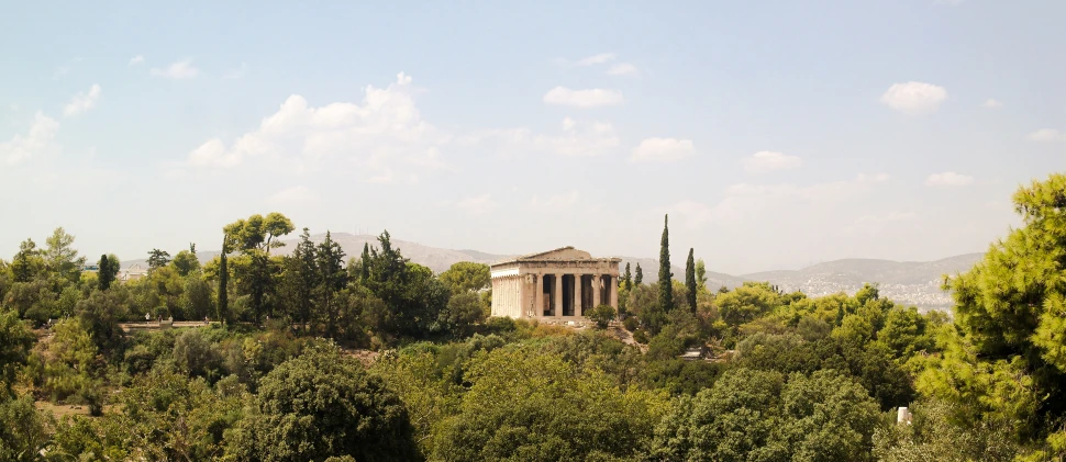 an old greek temple nestled amongst the greenery