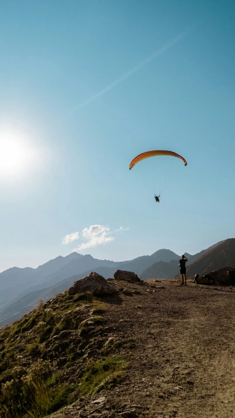 a kite is flown in the air above a hill