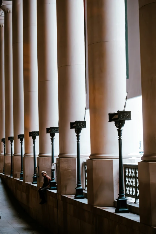 people are sitting next to some pillars