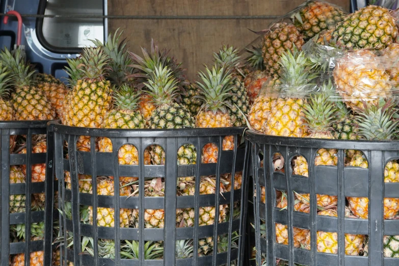 several containers full of pineapples sitting on a table