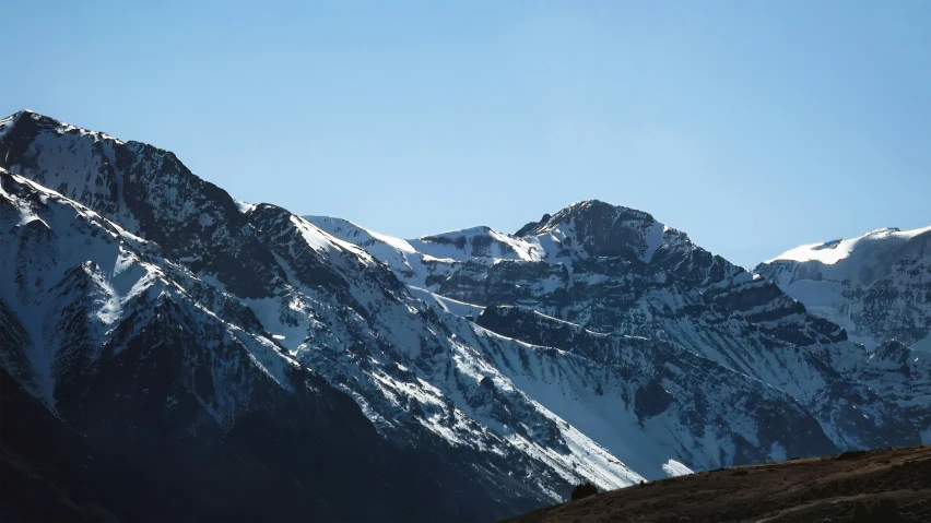 the snowy mountains range on a bright sunny day