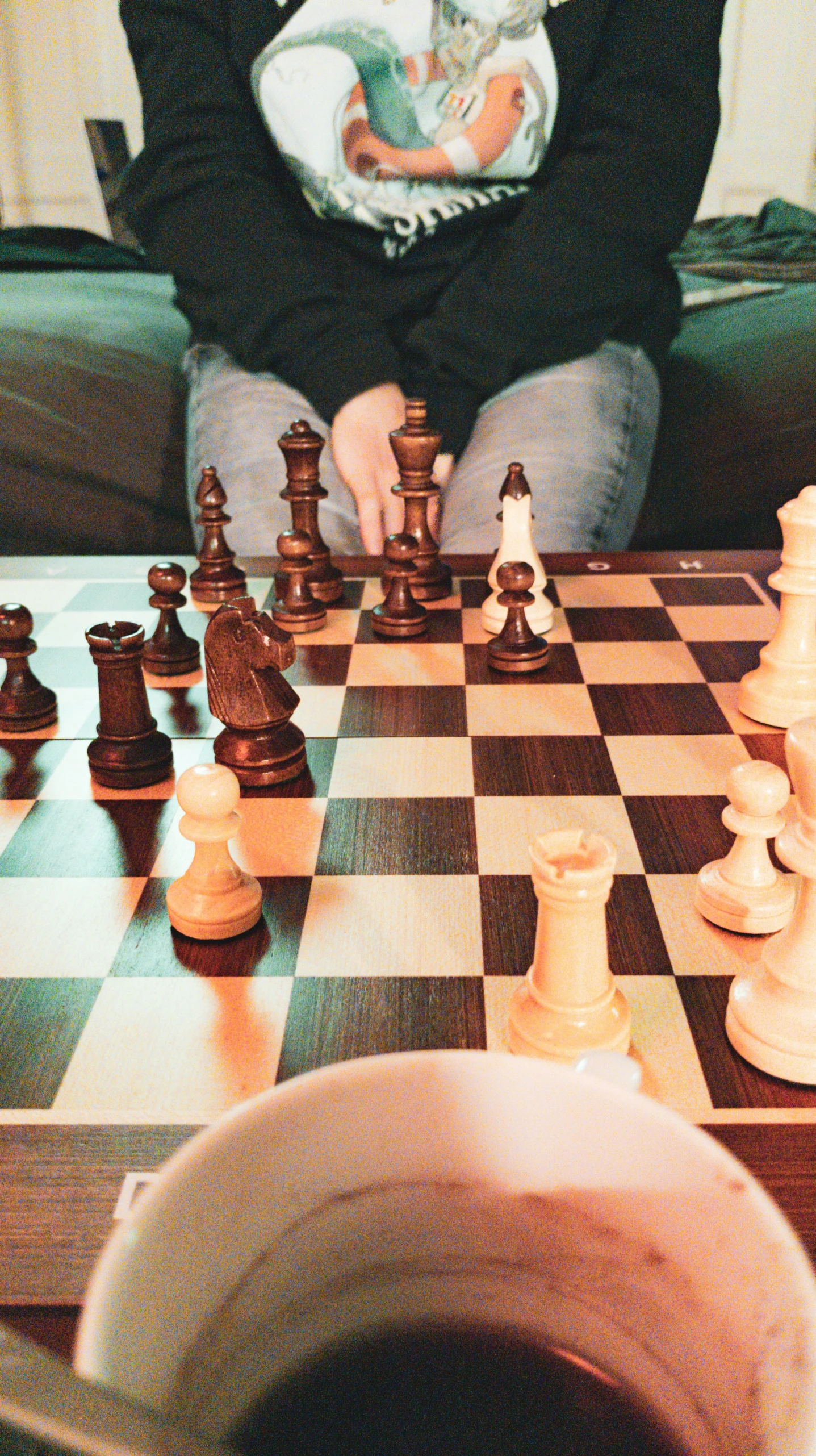 a small child playing with chess on a table