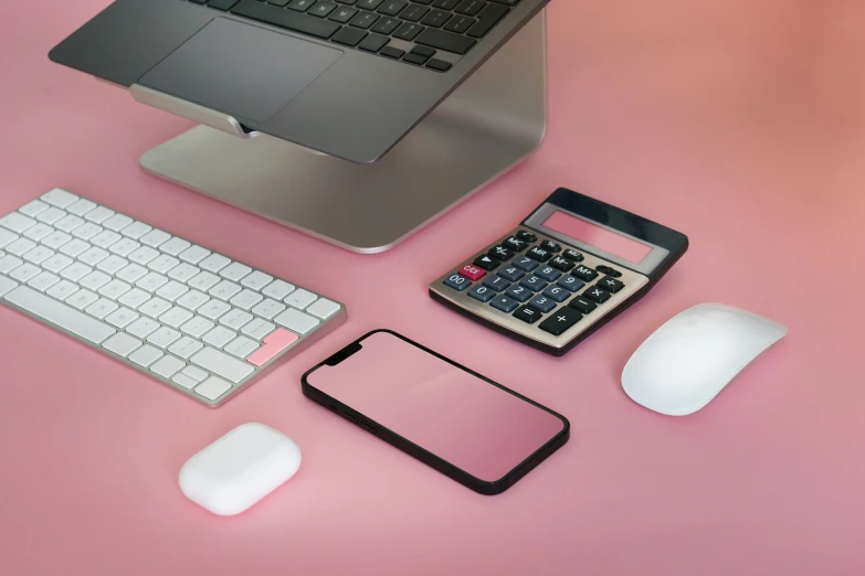 various electronic devices on display in a pink table