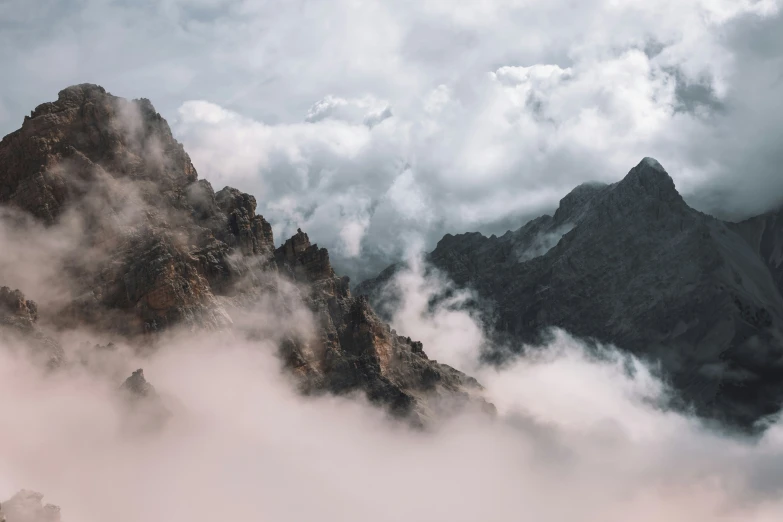 a mountain surrounded by clouds and fog