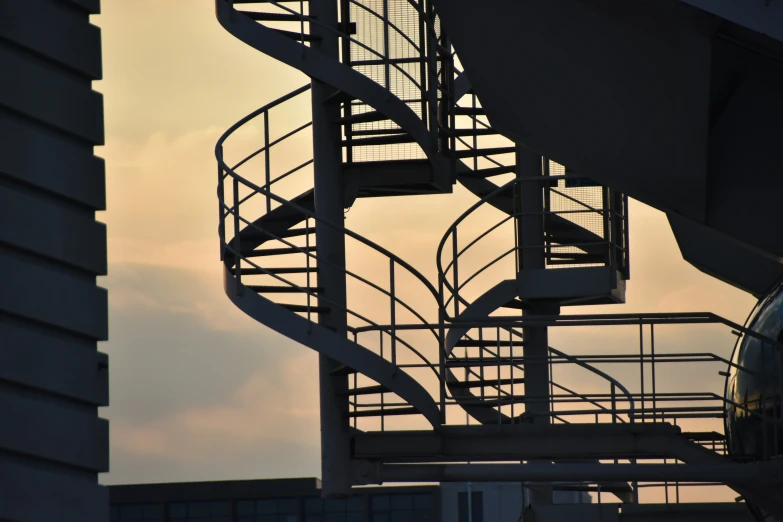 a spiral staircase with an airplane behind it