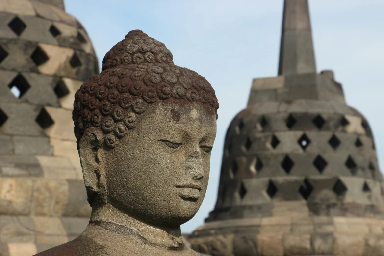 a statue is standing outside by some buildings