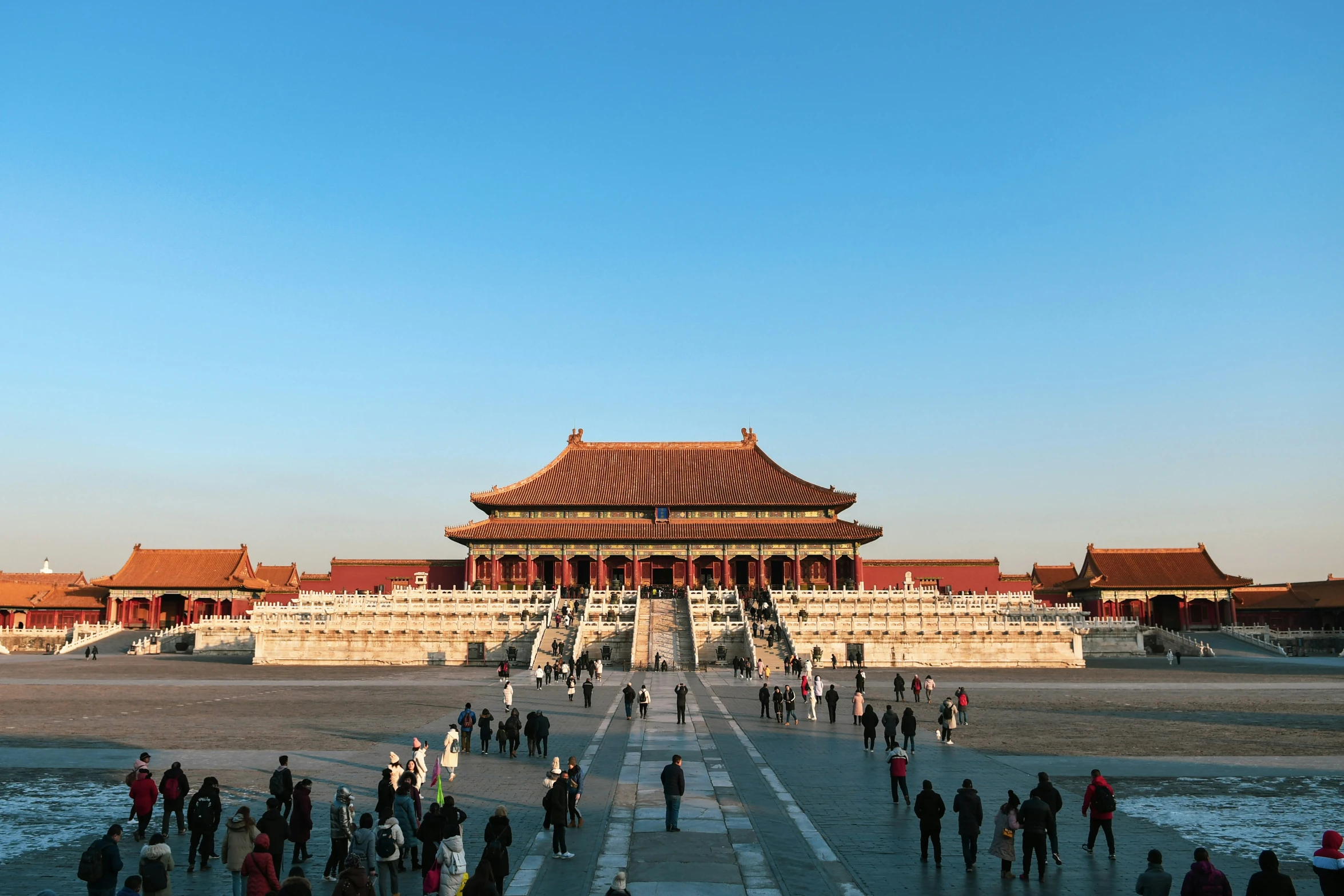 a crowd of people standing in front of a palace