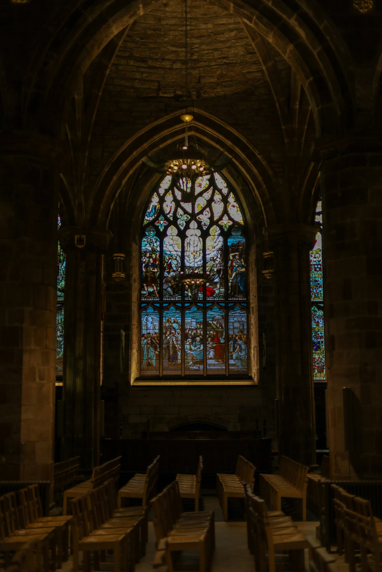 a cathedral filled with wooden tables and wooden chairs