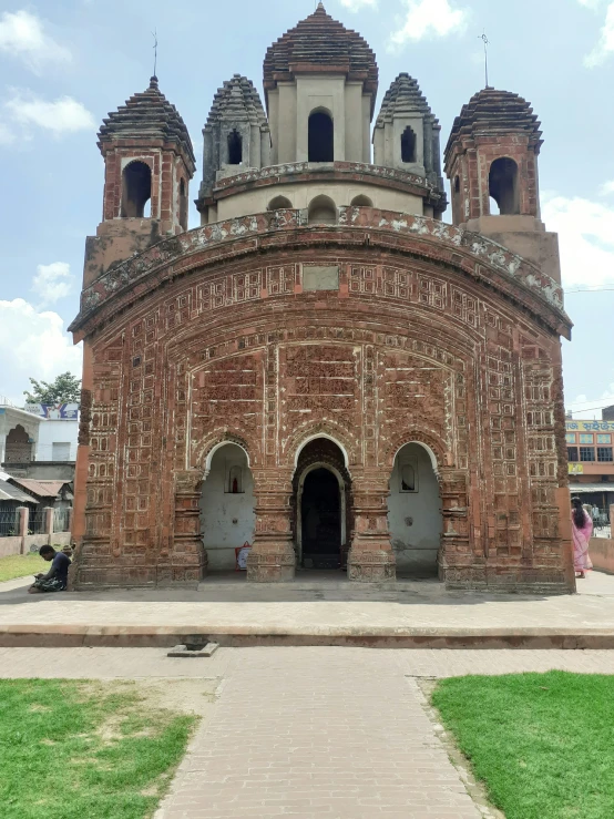 an old, crumbling church with a pathway going around it