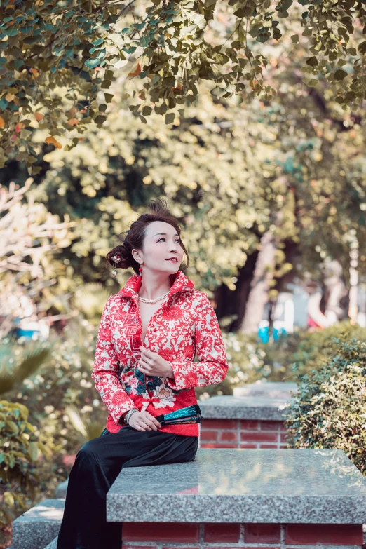 a woman wearing red shirt and black pants