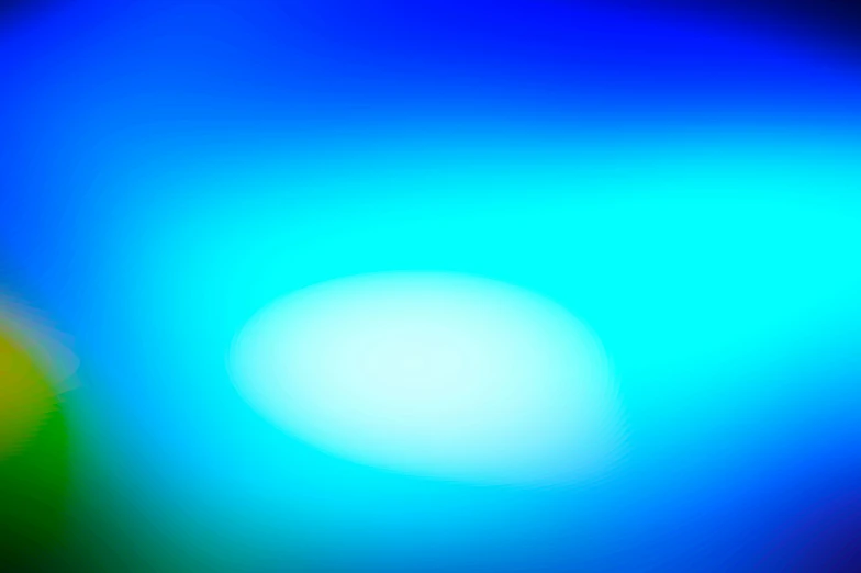 a blurry background with bright colors and a blue light