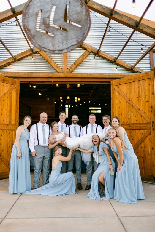 a group of people wearing dresses pose for a picture together