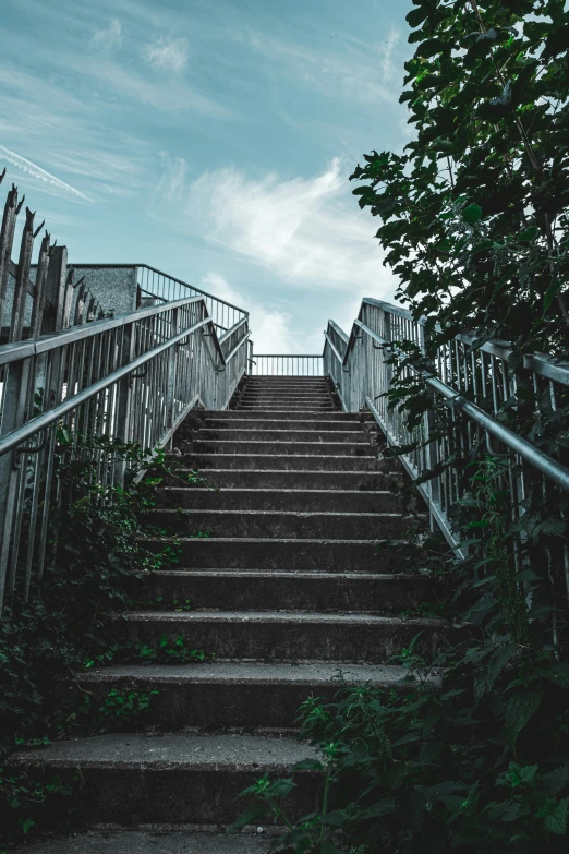 this stair flight leads to a gate that is partially open