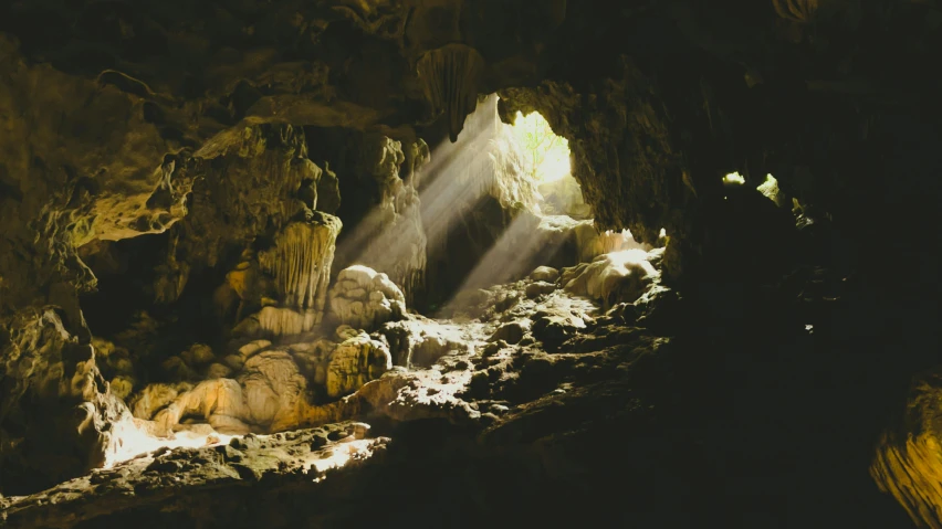 sunlight beams shining through a cave opening