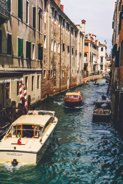 several boats traveling down a canal in venice