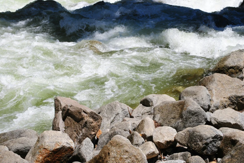 the rocks are covered with water and foam