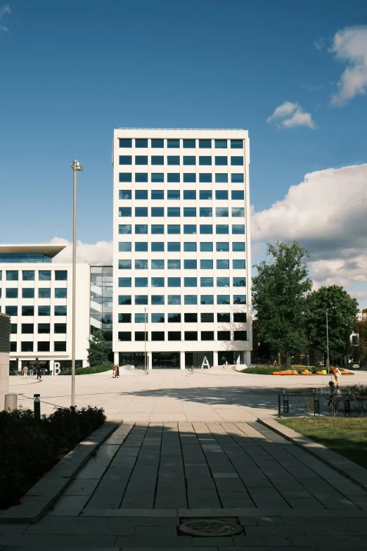 a big white building sitting on top of a green field