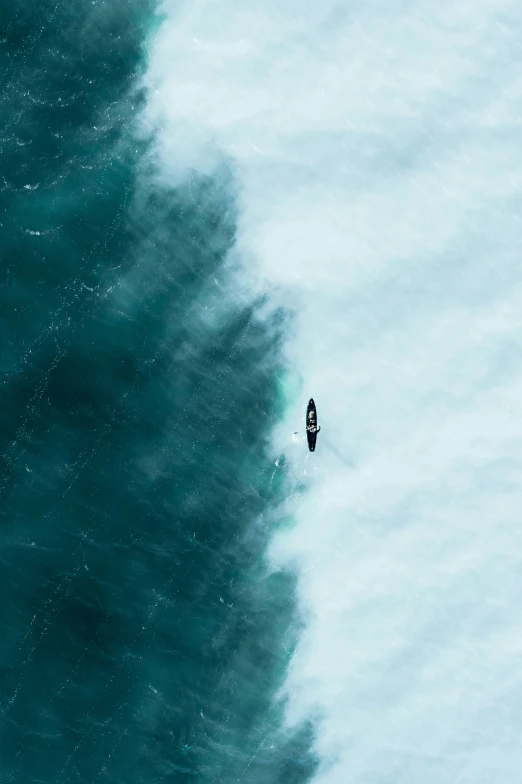 two people on surfboards riding on an ocean wave