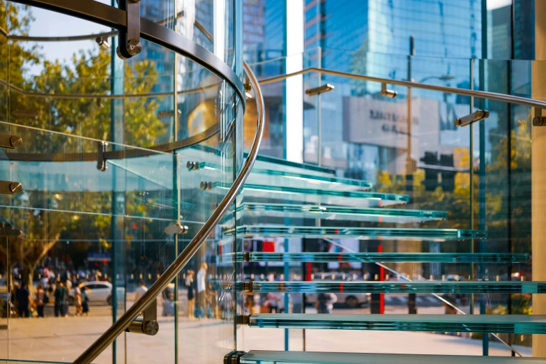 an iron and glass staircase in front of a building