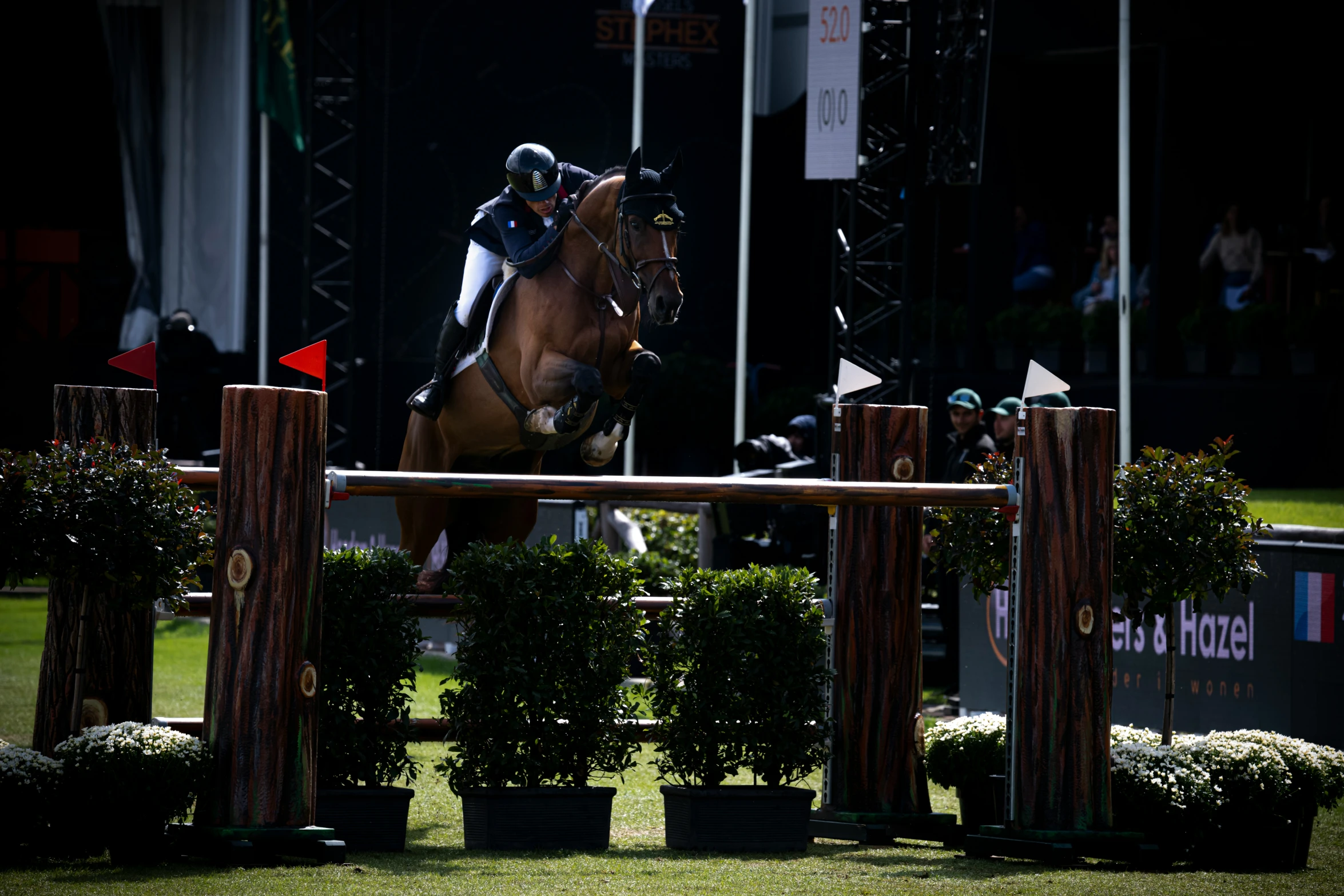 a horse and rider are jumping over obstacles