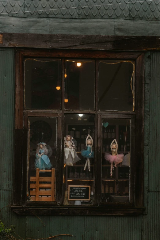 doll ornaments displayed in the window of a shop