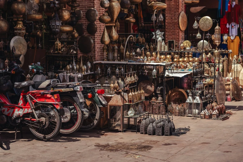 two motorcycles are parked outside of a store