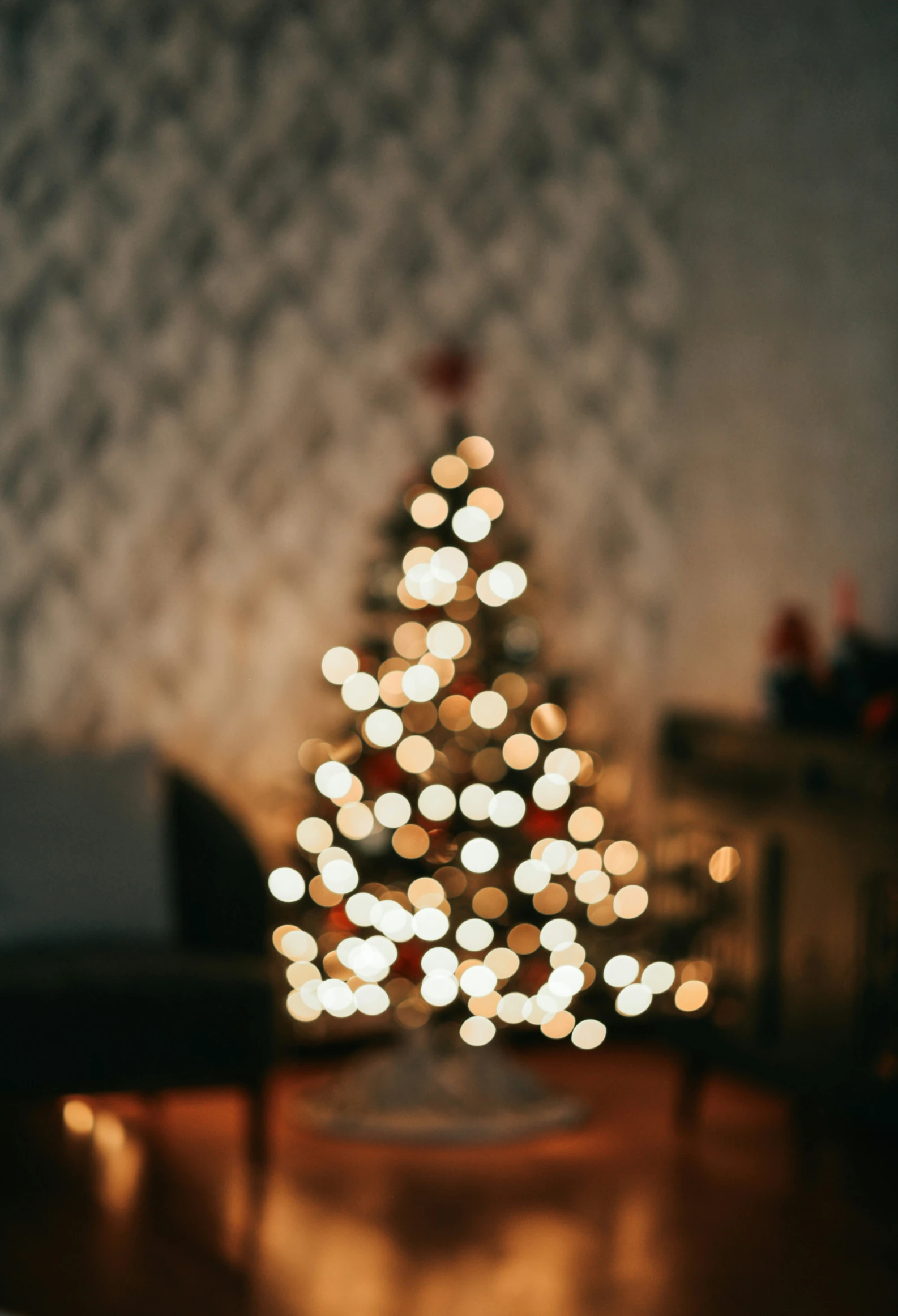 the lights in front of the christmas tree glow brightly