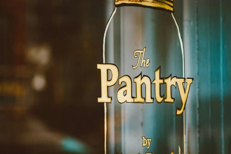 an empty glass bottle is sitting on a shelf