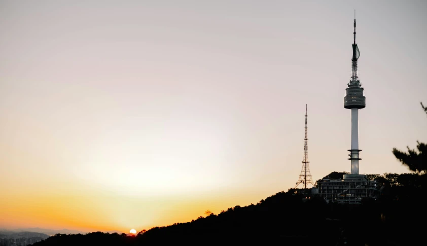 there is a tower and a clock on top of a hill