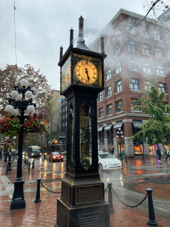 a clock tower standing in the middle of a street