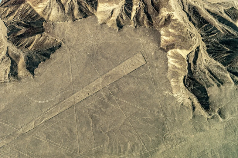 an aerial view of the mountains with a plane