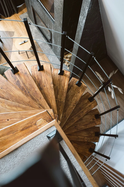 the top view of a wooden staircase with chrome handrails