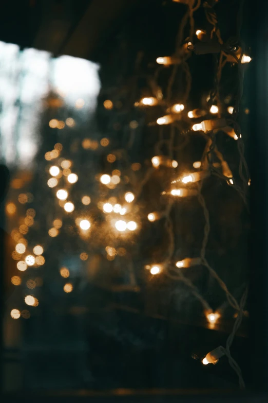 a blurry image of lights reflecting off the side of a window