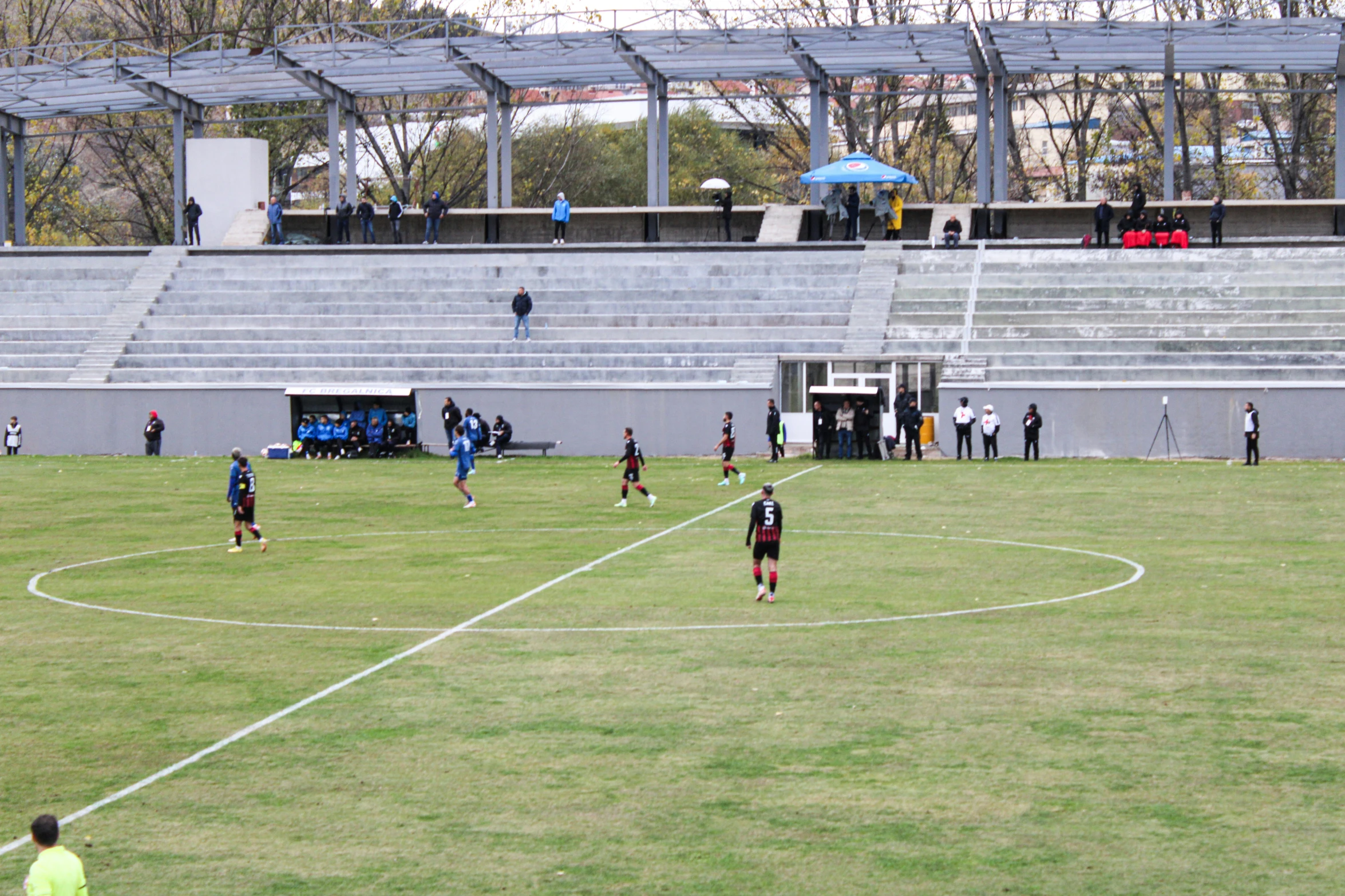 a group of men standing on top of a soccer field