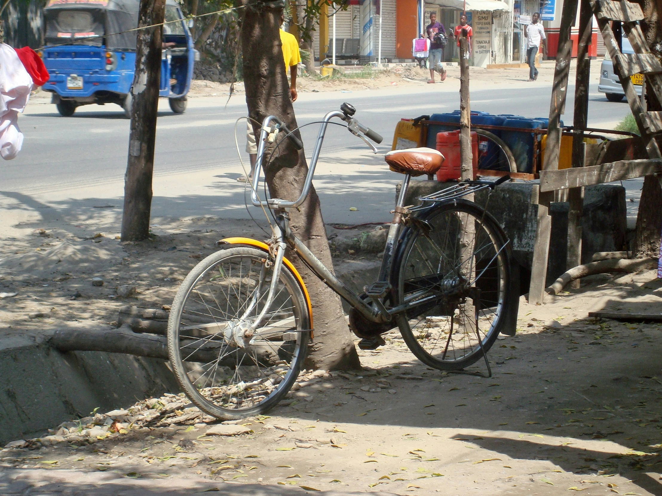 a bicycle is parked next to some tree and a basket