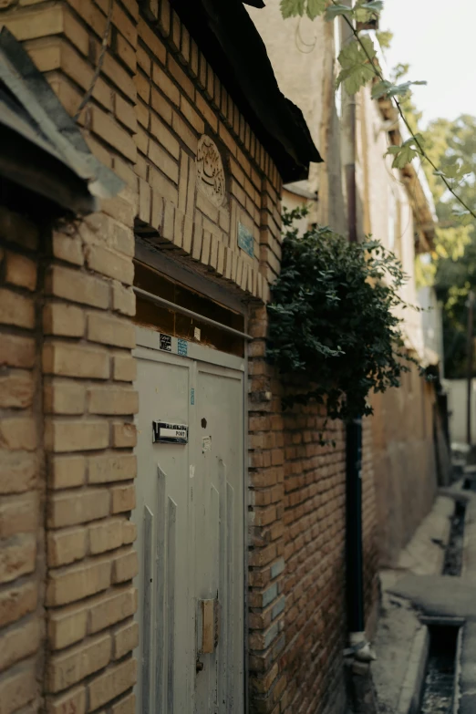 the door of a small old building, showing the brick facade