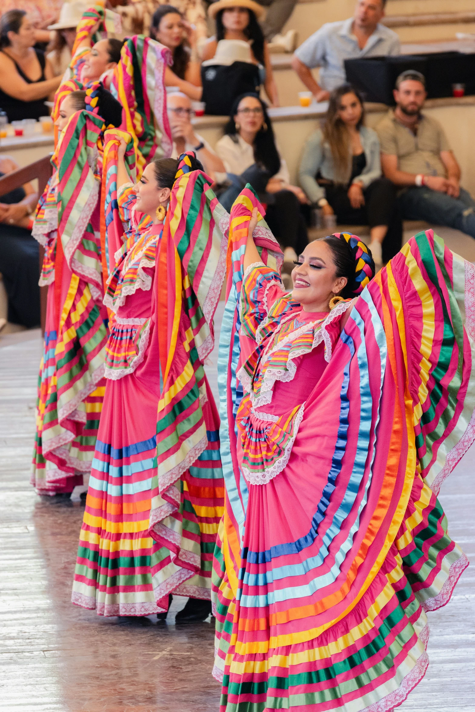 two women in colorful dresses and their arms are folded