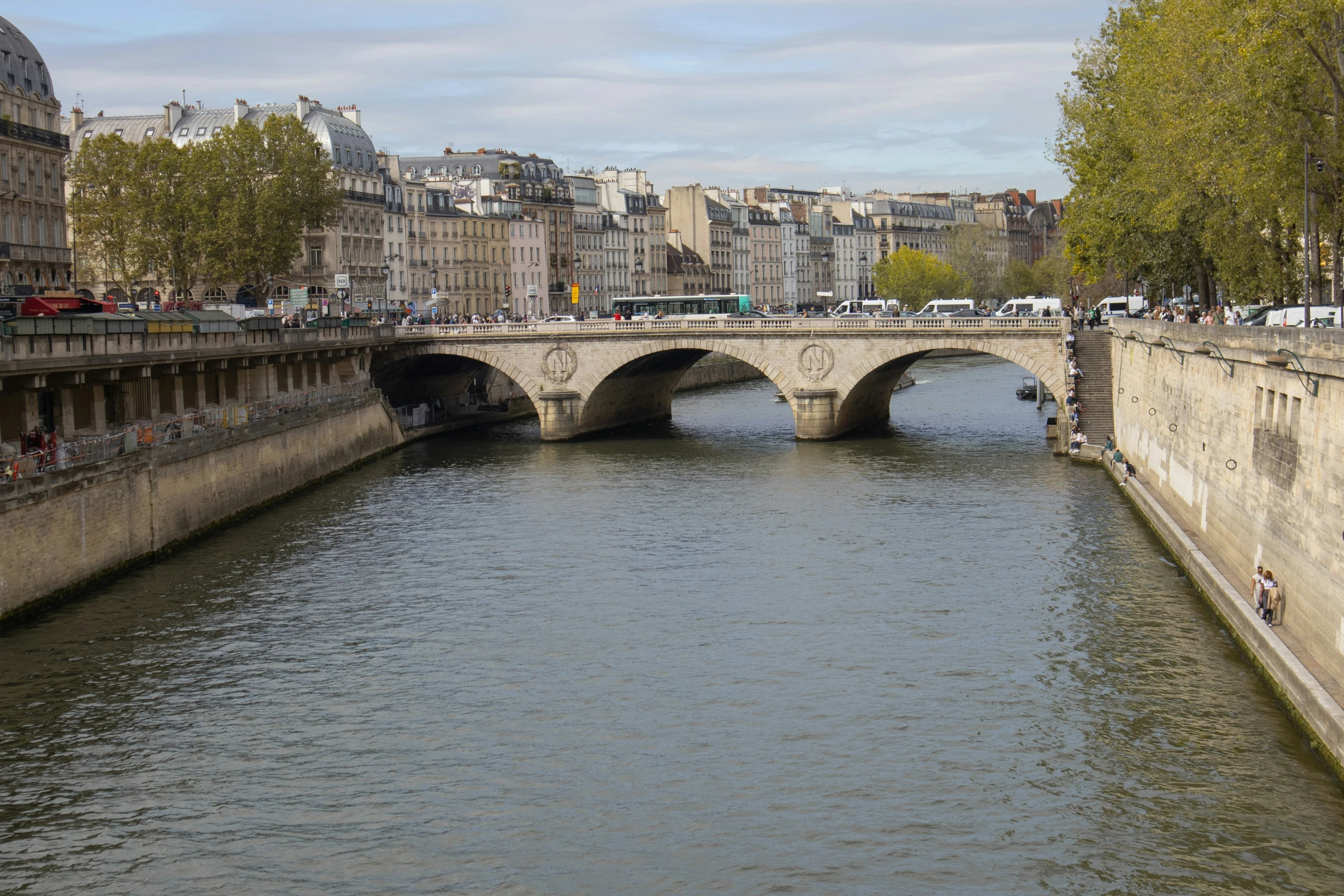 the river in front of some buildings and people