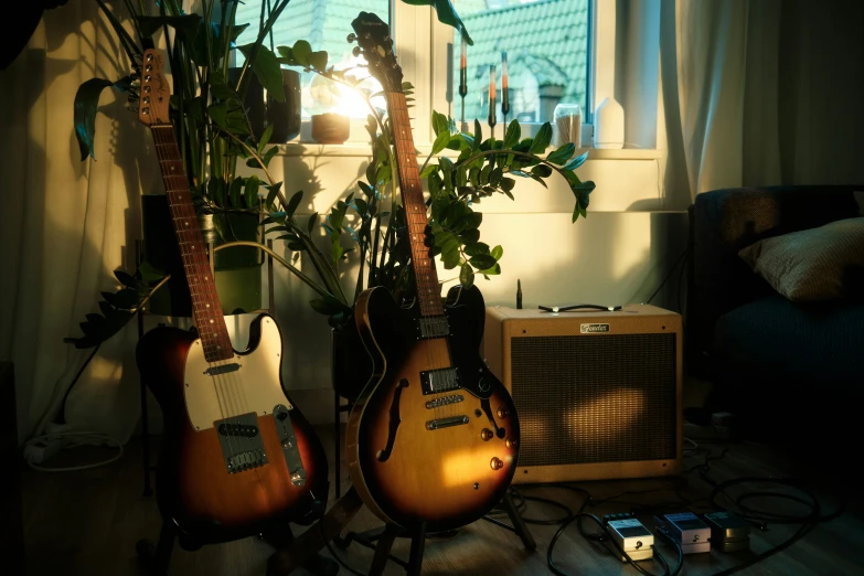 a close up of three guitars next to a window