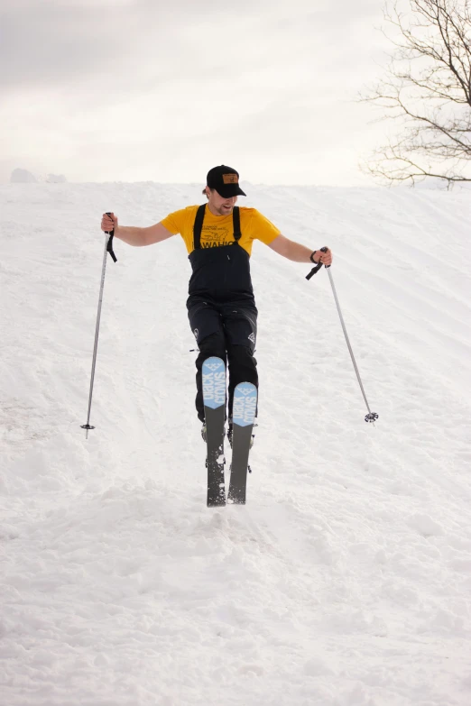 a person wearing skis riding on top of snow covered hill