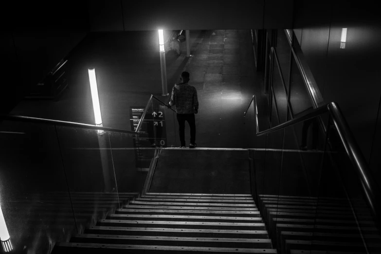 a person stands on the stairs in the dark